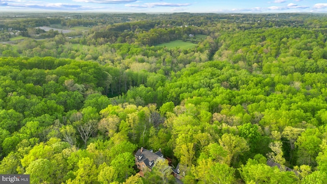 birds eye view of property featuring a view of trees