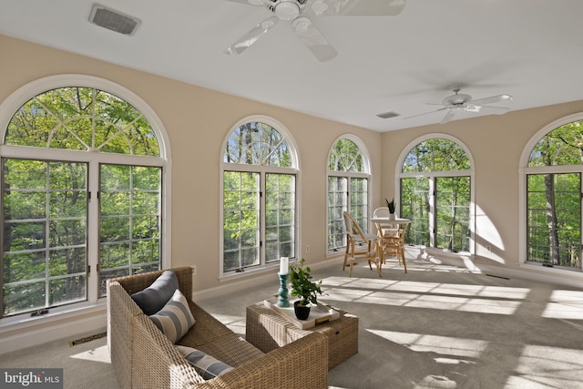 sunroom / solarium with carpet floors, baseboards, and visible vents