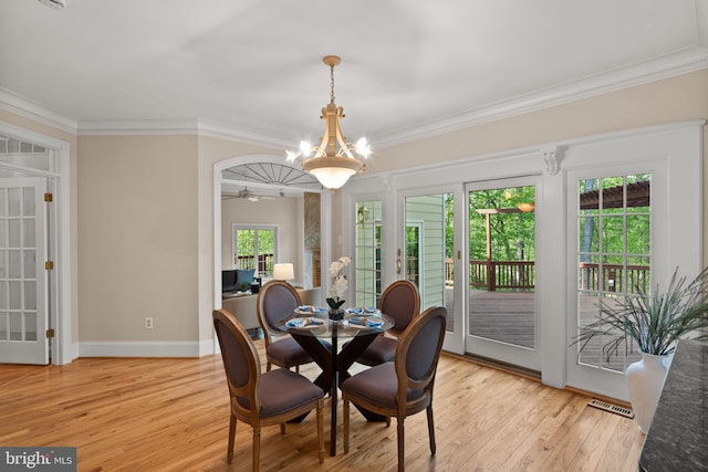 dining room featuring crown molding and light wood-style floors
