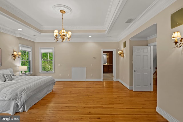 bedroom with a notable chandelier, a raised ceiling, light wood finished floors, baseboards, and ornamental molding