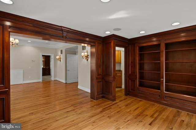 unfurnished room featuring crown molding, a notable chandelier, light wood-style floors, recessed lighting, and baseboards