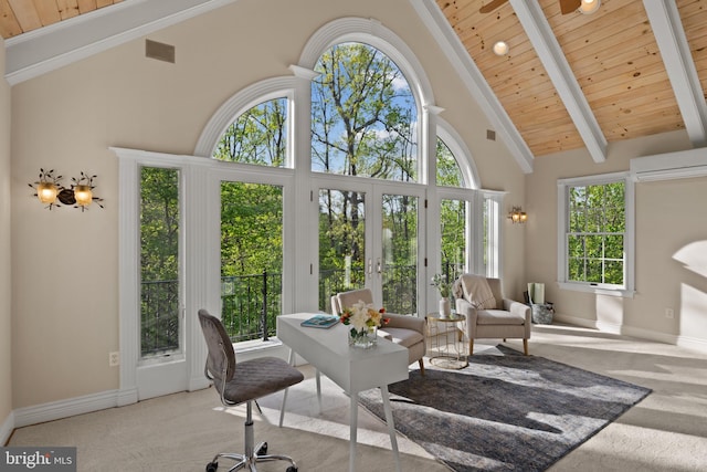 sunroom featuring an AC wall unit, beam ceiling, a wealth of natural light, and french doors