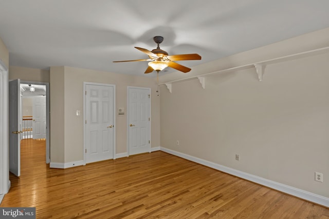 unfurnished bedroom featuring baseboards, ceiling fan, and light wood-style flooring