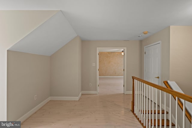 additional living space featuring baseboards, ceiling fan, wood finished floors, and lofted ceiling