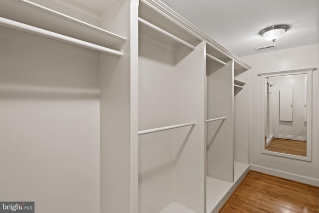 walk in closet featuring wood finished floors and visible vents