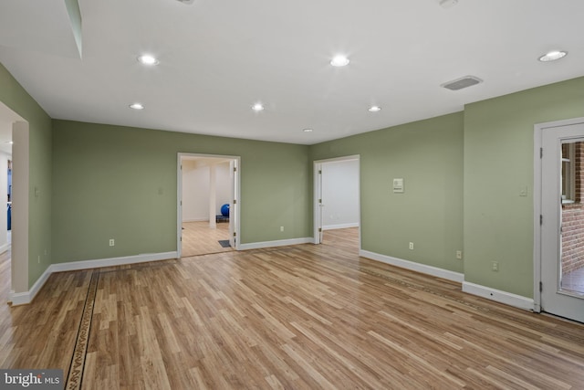spare room with recessed lighting, baseboards, and light wood-type flooring