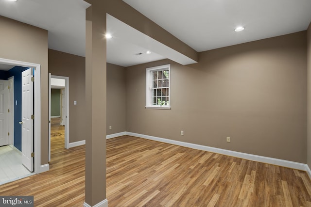 below grade area featuring baseboards, recessed lighting, and light wood finished floors