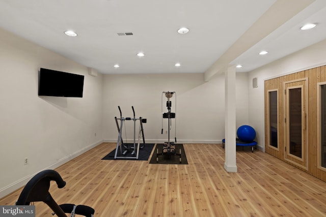 exercise room with recessed lighting, baseboards, light wood finished floors, and visible vents
