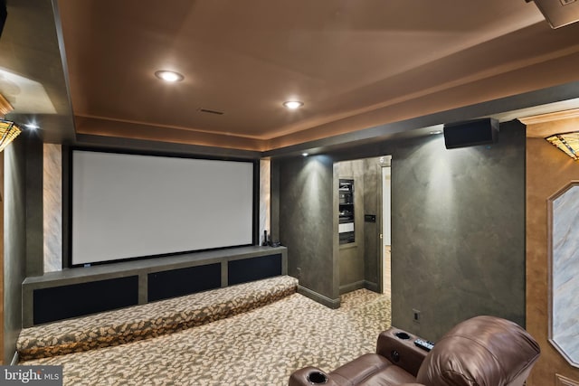 carpeted home theater room with recessed lighting and a raised ceiling