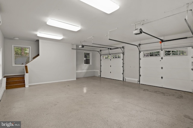 garage with baseboards and a garage door opener
