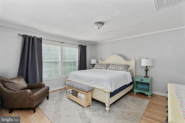 312 Richards Ferry Rd, Fredericksburg, VA 22406 - bedroom with light wood-style floors, a textured ceiling, ornamental molding, and baseboards
