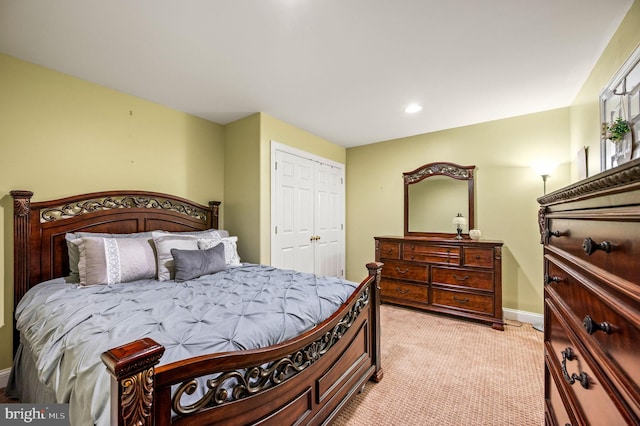 bedroom featuring baseboards, recessed lighting, light carpet, and a closet