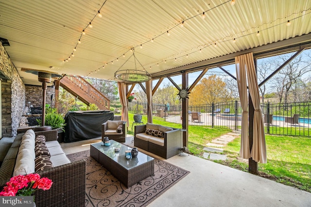 view of patio with a grill, stairway, fence, a fenced in pool, and outdoor lounge area