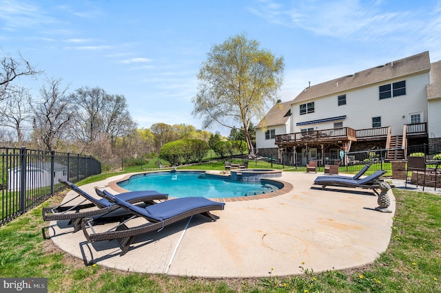 view of swimming pool featuring fence, a deck, a patio area, and a pool with connected hot tub