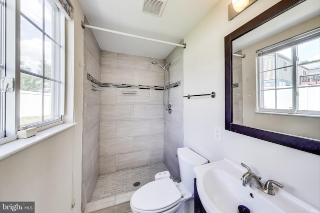 7910 E Nalley Rd, Hyattsville, MD 20785 - bathroom with healthy amount of natural light, a sink, toilet, and tiled shower