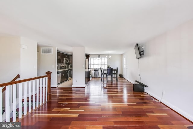 7910 E Nalley Rd, Hyattsville, MD 20785 - living room with wood finished floors, a chandelier, and baseboards