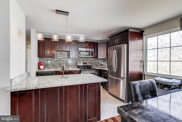 7910 E Nalley Rd, Hyattsville, MD 20785 - kitchen with appliances with stainless steel finishes, backsplash, a peninsula, and light stone countertops