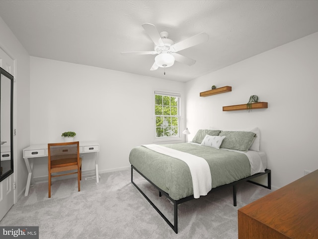 bedroom with carpet flooring, baseboards, and a ceiling fan