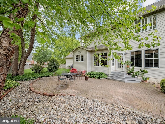 back of property with a patio area and fence