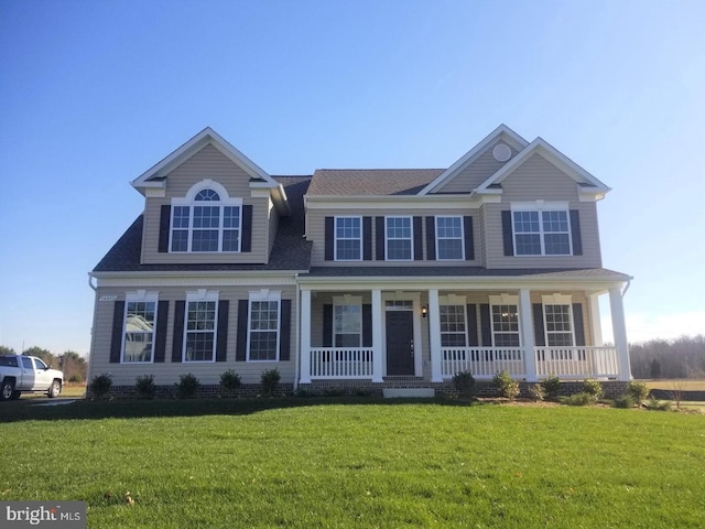 60 Persimmon Hills Ct, Sunderland, MD 20689 - view of front of house with covered porch, a front lawn, and a shingled roof