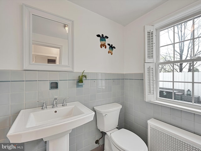 341 Creston Rd, York, PA 17403 - half bathroom featuring toilet, tile walls, a sink, and radiator