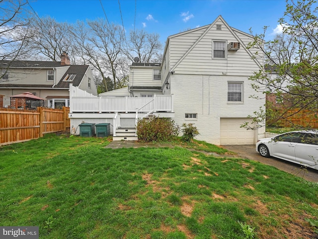 341 Creston Rd, York, PA 17403 - back of property featuring a yard, an attached garage, aphalt driveway, fence, and a wooden deck