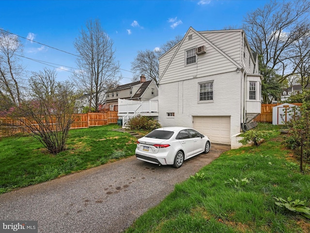 341 Creston Rd, York, PA 17403 - view of property exterior featuring an attached garage, fence, a lawn, and driveway