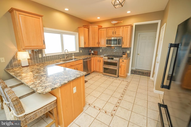 13470 Harrison Landing Rd, Princess Anne, MD 21853 - kitchen with baseboards, backsplash, a sink, and stainless steel appliances