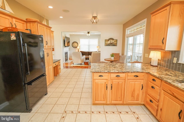 13470 Harrison Landing Rd, Princess Anne, MD 21853 - kitchen featuring a wealth of natural light, a peninsula, ceiling fan, and freestanding refrigerator