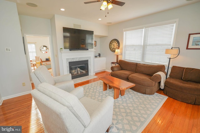 13470 Harrison Landing Rd, Princess Anne, MD 21853 - living area with a high end fireplace, baseboards, recessed lighting, a ceiling fan, and light wood-style floors