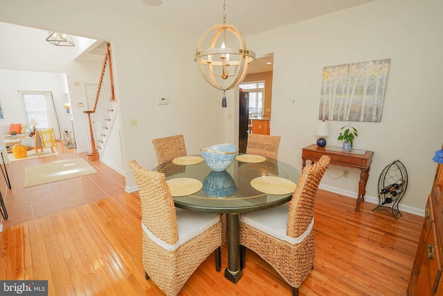 13470 Harrison Landing Rd, Princess Anne, MD 21853 - dining area featuring an inviting chandelier, baseboards, stairway, and light wood finished floors