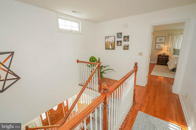 13470 Harrison Landing Rd, Princess Anne, MD 21853 - corridor with baseboards, visible vents, an upstairs landing, and light wood-style floors