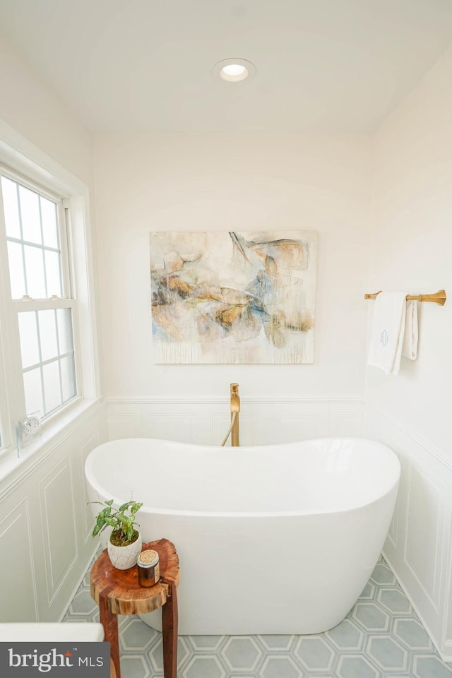 13470 Harrison Landing Rd, Princess Anne, MD 21853 - bathroom featuring a decorative wall, a wainscoted wall, a freestanding tub, and recessed lighting