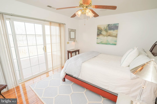 13470 Harrison Landing Rd, Princess Anne, MD 21853 - bedroom with visible vents, wood finished floors, ceiling fan, and access to outside