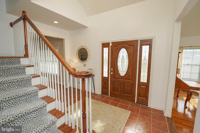 13470 Harrison Landing Rd, Princess Anne, MD 21853 - entrance foyer featuring vaulted ceiling, dark tile patterned floors, baseboards, and stairs