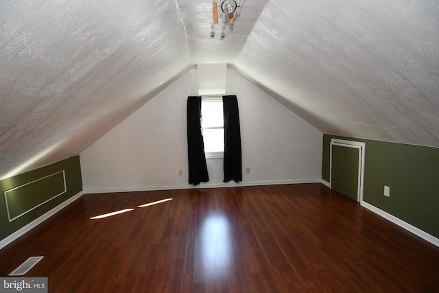 713 Cooper St, Florence, NJ 08518 - additional living space featuring baseboards, visible vents, a textured ceiling, and lofted ceiling