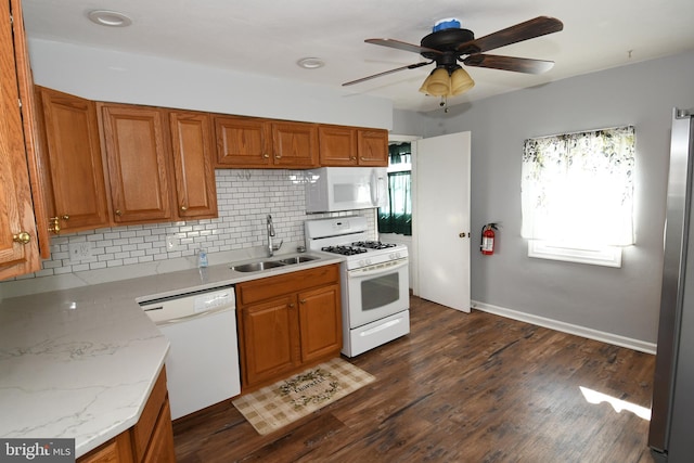 713 Cooper St, Florence, NJ 08518 - kitchen with tasteful backsplash, white appliances, brown cabinets, ceiling fan, and a sink