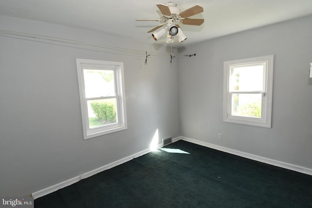713 Cooper St, Florence, NJ 08518 - spare room with dark carpet, visible vents, ceiling fan, and baseboards
