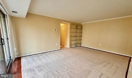 unfurnished room featuring baseboards and visible vents