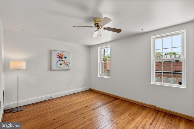 empty room with baseboards, plenty of natural light, light wood-style flooring, and ceiling fan