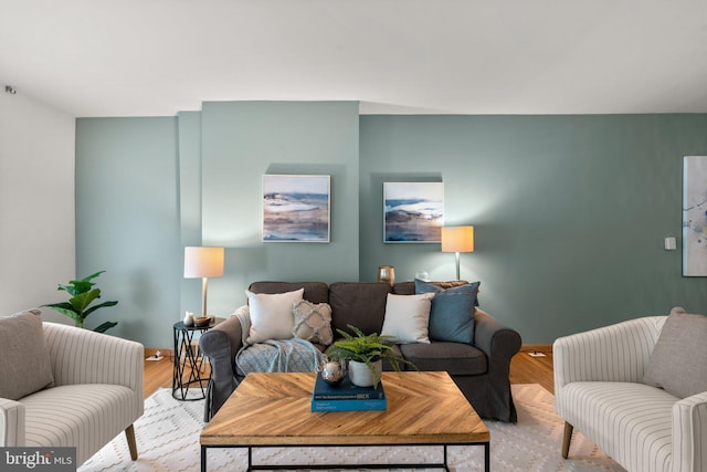 living room featuring light wood-type flooring and baseboards