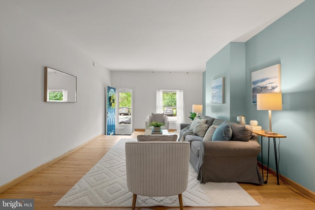living area featuring light wood finished floors and baseboards