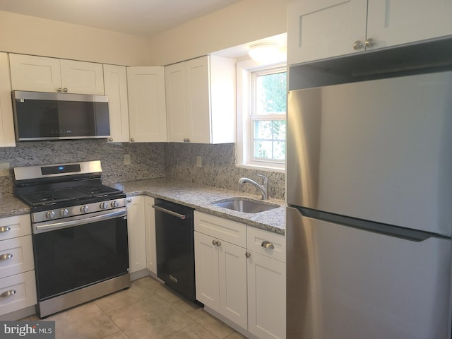 29 Pine Dr, Manchester, PA 17345 - kitchen with appliances with stainless steel finishes, a sink, tasteful backsplash, and white cabinetry
