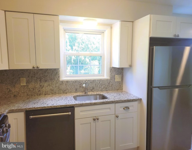 29 Pine Dr, Manchester, PA 17345 - kitchen with freestanding refrigerator, dishwasher, a sink, and white cabinetry