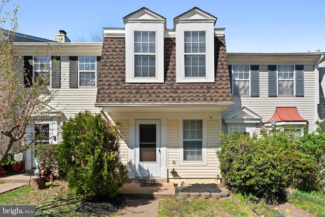 multi unit property featuring roof with shingles