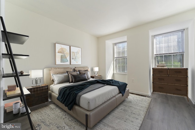 bedroom with baseboards and wood finished floors