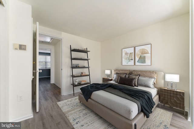 bedroom featuring baseboards and light wood-style floors