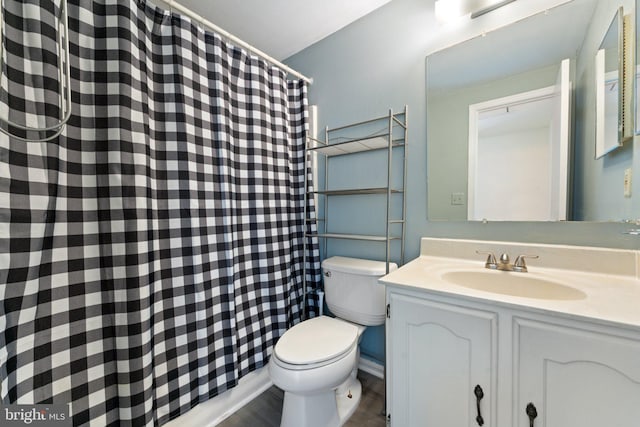 full bathroom featuring wood finished floors, vanity, curtained shower, and toilet