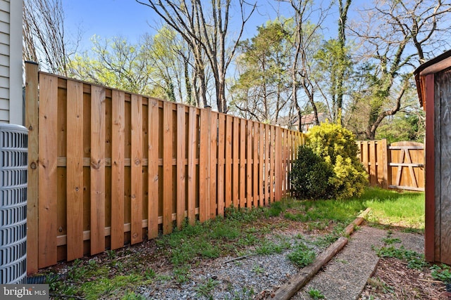 view of yard featuring fence and cooling unit