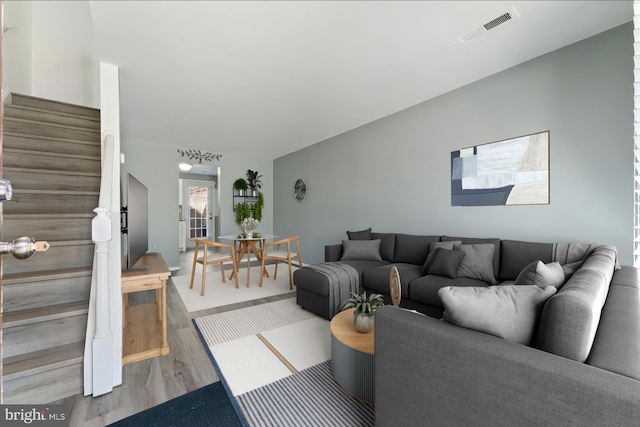 living area with wood finished floors and visible vents